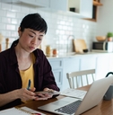 stressed woman reviewing bills and finances