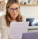 woman reading financial document