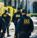 IRS tax agents standing in front of a mansion for a raid