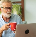 Boomer aged man working on a laptop