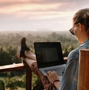 businesswoman working on laptop in cafe on the rock