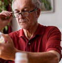 Senior man taking prescription medicine
