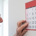Older man looking at calendar
