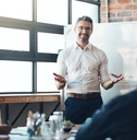 ceo and whiteboard with presentation for business people
