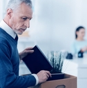 boomer aged man cleaning out desk