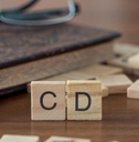 scrabble tiles spelling out cd