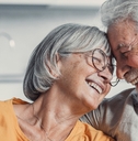 Senior couple smiling and hugging each other