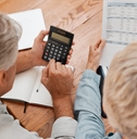 senior couple with calculator planning financial investments