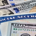 social security benefits identification card with dollar bills