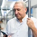 Man in the subway looking at his phone