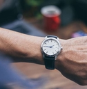 checking luxury watch to check time