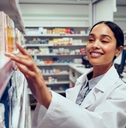 Pharmacist picking medication from shelf