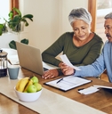 senior couple with bills