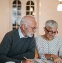 senior couple calculating their expenses