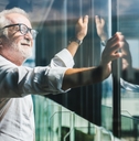 businessman standing near office window