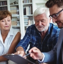 senior couple consulting with financial advisor