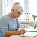 senior waman sitting at the table