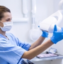 dental assistant adjusting light 