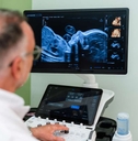 gynecologist using modern ultrasound scanner