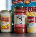 Several containers of grocery food products on kitchen counter