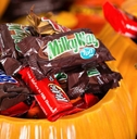 Decorative pumpkins filled with assorted Halloween candy