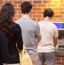 People in line to withdraw cash from ATM