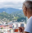 retired man viewing city on balcony