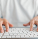 Close up of hands on keyboard