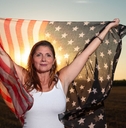 gen x woman holding an american flag