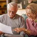 Happy older couple with paperwork