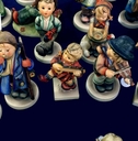 hummel porcelain figurines on a dark background