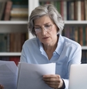 older woman reviewing papers