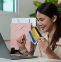 Woman with multiple credit cards and computer