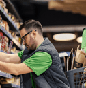 Grocery store workers stocking shelves