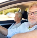 happy senior couple driving in car 