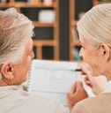 Older couple financial planning and looking at each other