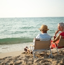 elderly sitting in chairs at the beach