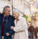 retired couple walking in city on a winter day