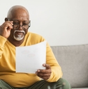older man reviewing paper