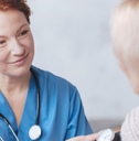 medical worker taking woman&#x27;s blood pressure