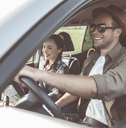 Couple driving in SUV