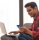 Man on laptop with credit card