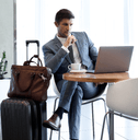Man sitting at airport lounge with luggage