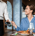 Woman using credit card at restaurant