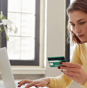 Woman with credit card on laptop