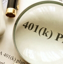 401(k) plan papers with magnifying glass