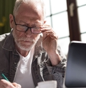 concentrated older man on laptop
