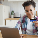 Woman on laptop with credit card