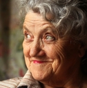 Older woman looking up smiling and thinking