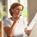 Woman looking at paperwork suspcious